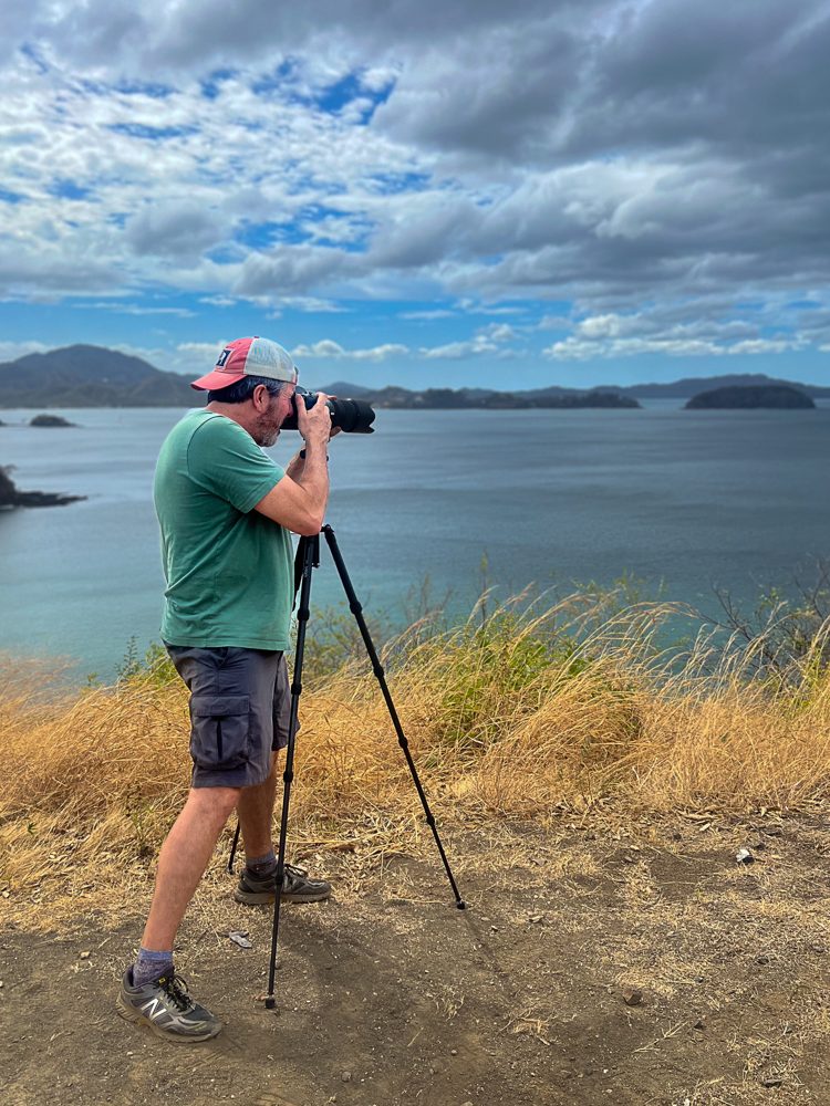 Chris Austermann photographing a coastline from a tripod