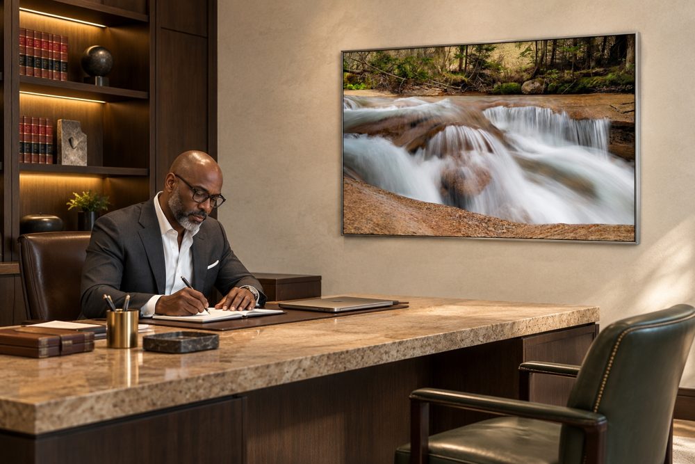 A large framed waterfall photograph on an office wall
